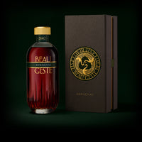 Armagnac bottle and beautiful box with 'Beau Geste' branding on a dark background