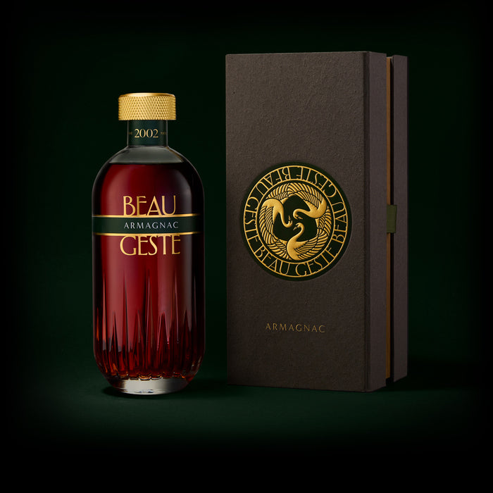 Armagnac bottle and beautiful box with 'Beau Geste' branding on a dark background